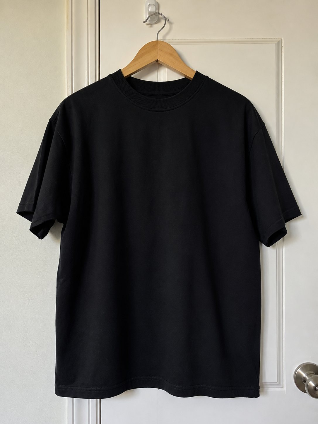 The plain black front of the Kaira tee, no print