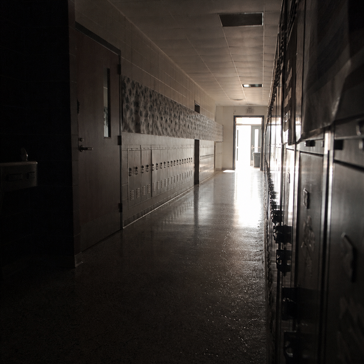 An empty American school hallway with a history timeline on the wall